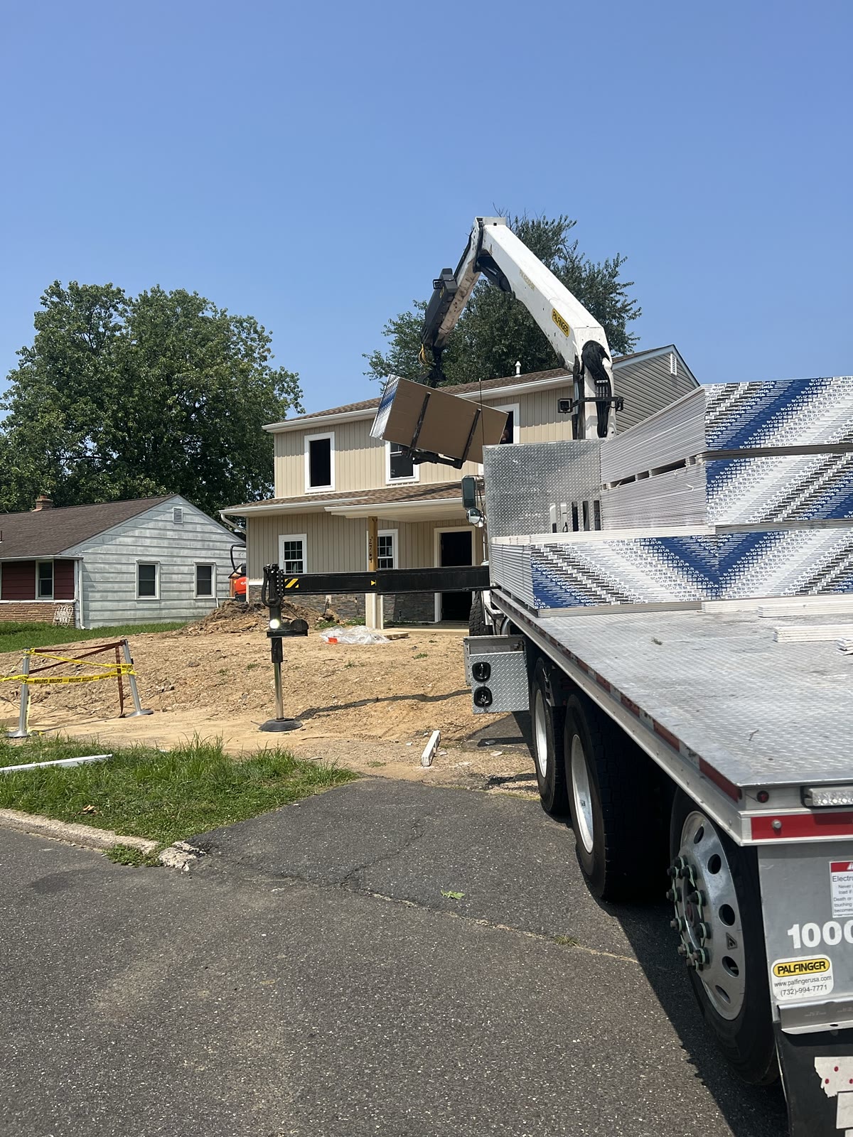Crane delivering drywall into a new construction home, Bensalem PA