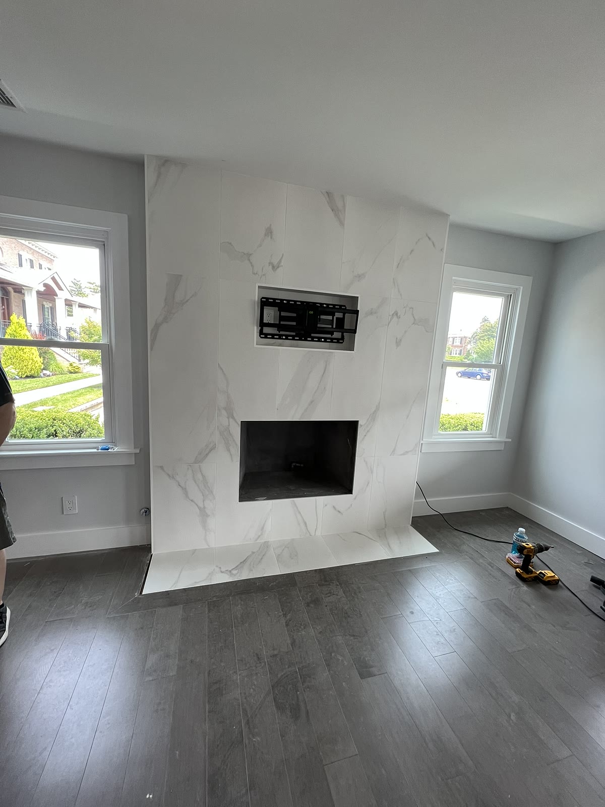 Marble fireplace feature wall with hardwood flooring