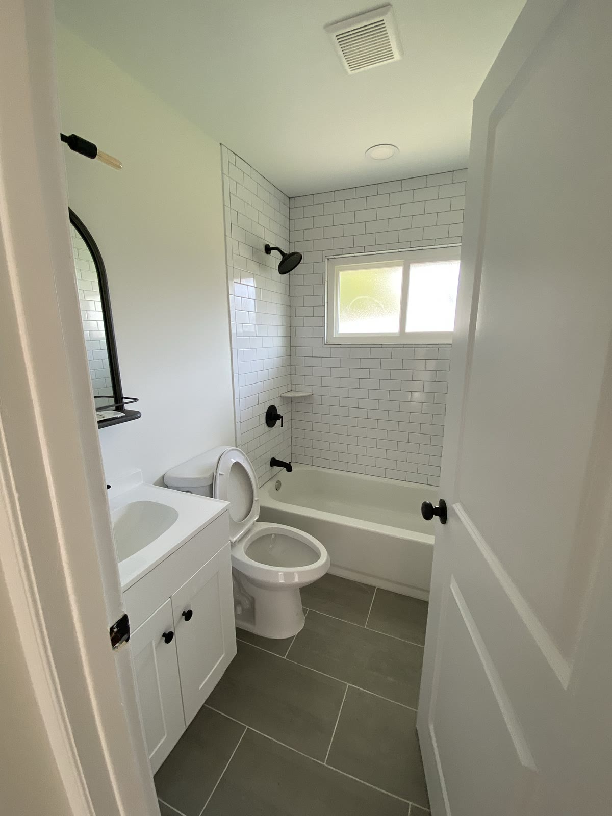 Bathroom remodel with subway tile tub surround and black fixtures, Levittown